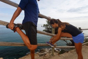 Couple stretching on dirt path